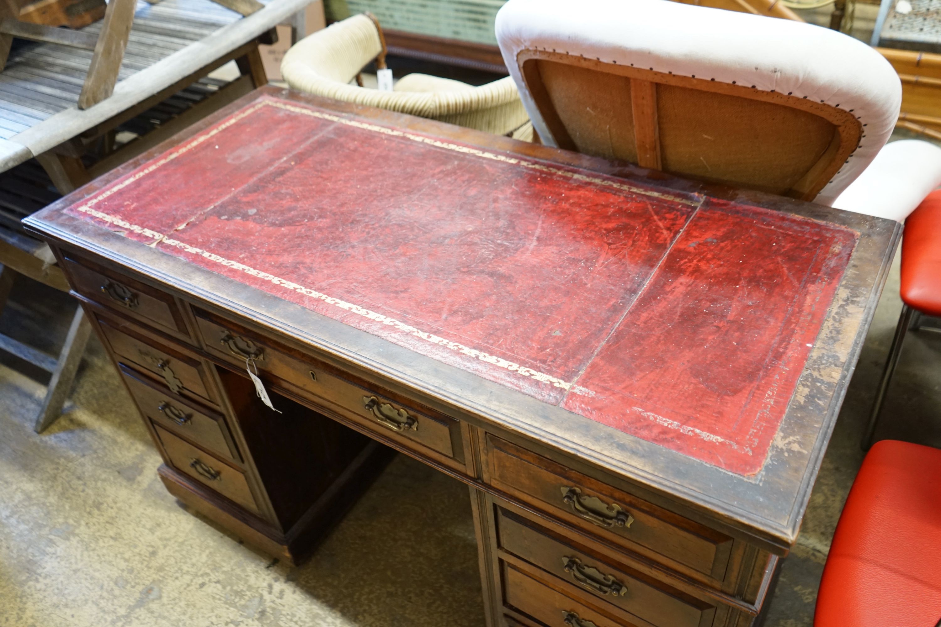 An early 20th century nine drawer writing desk, width 122cm depth 57cm height 75cm